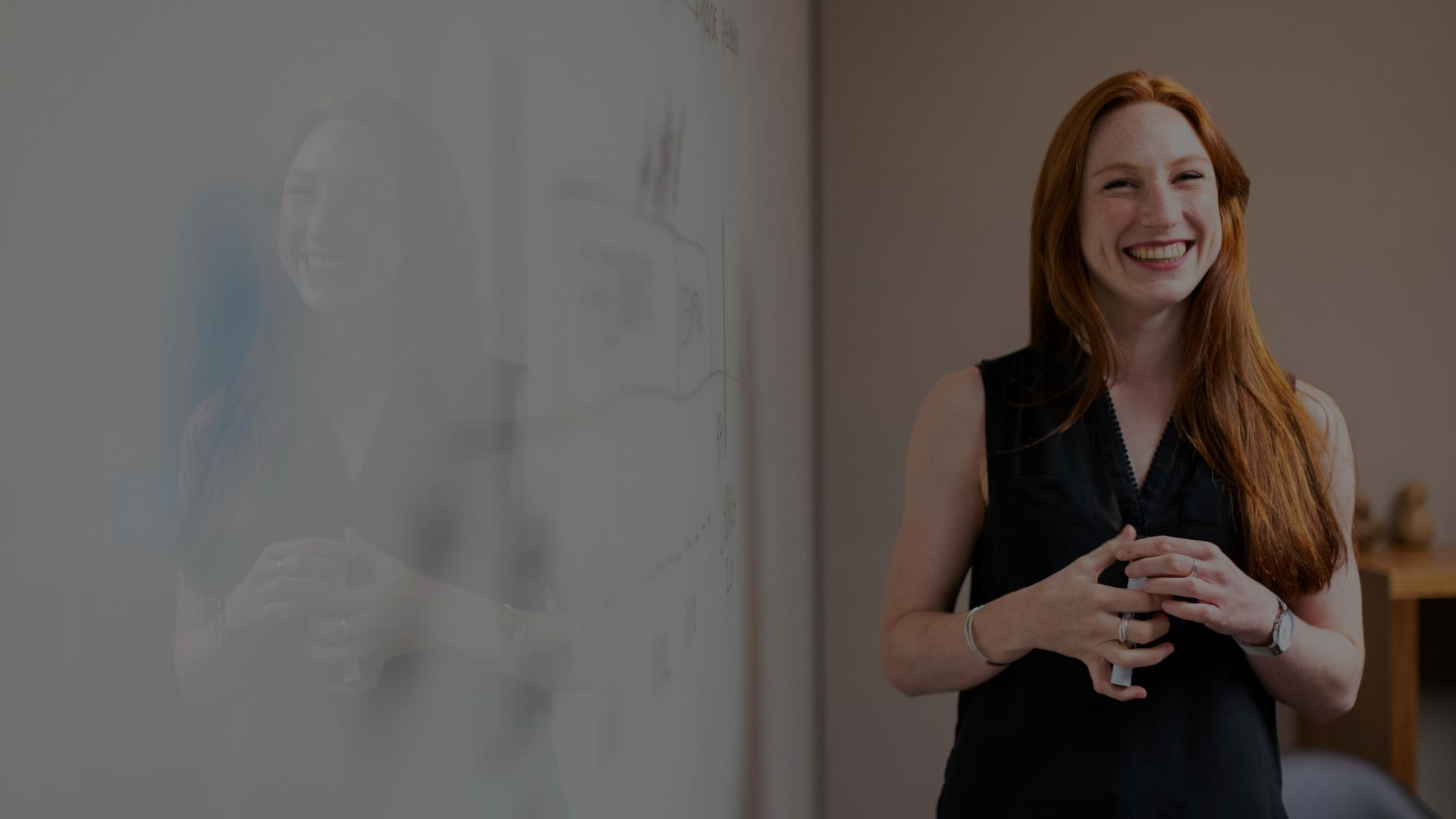 Woman beside a whiteboard