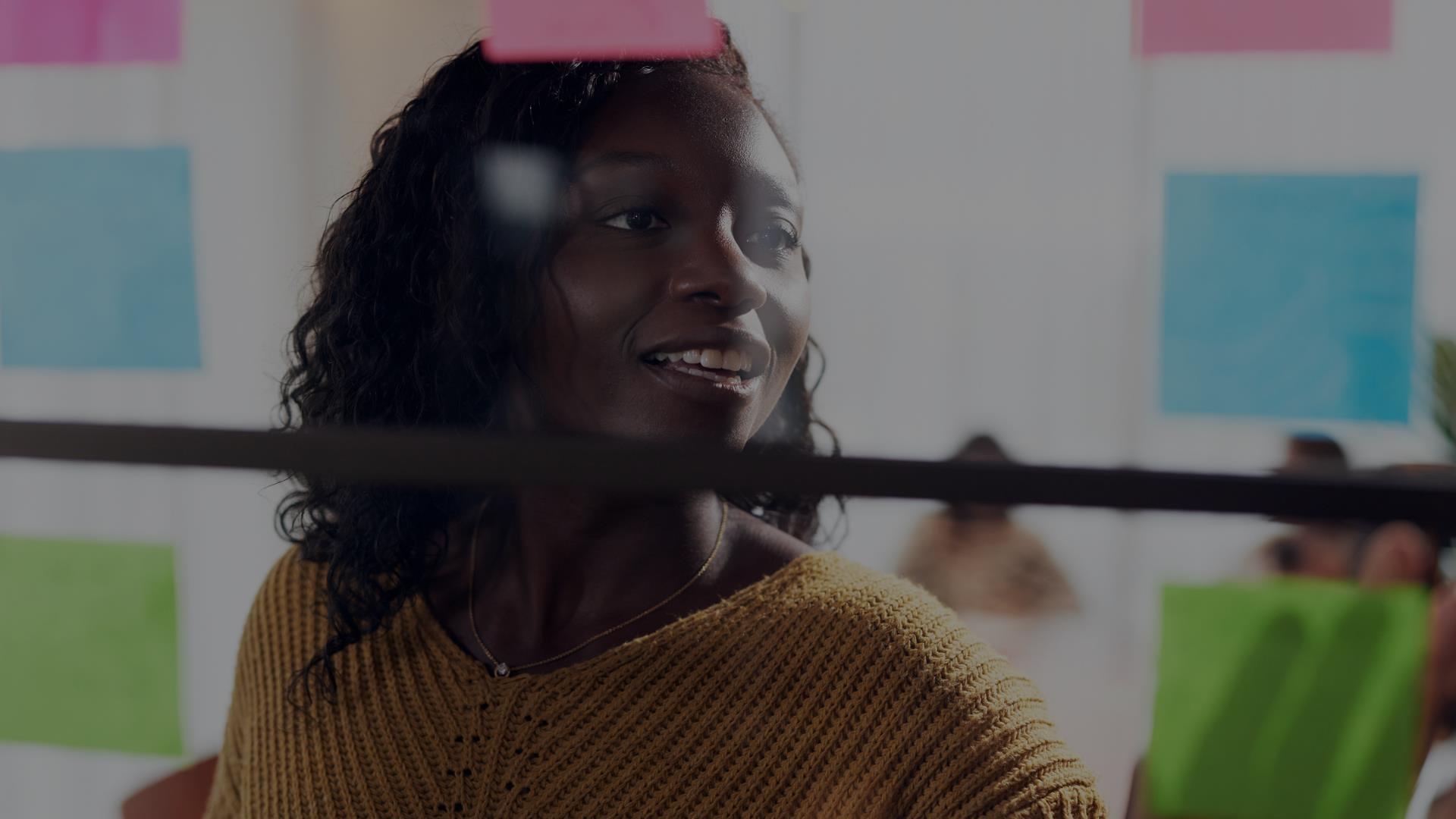 Woman sticking up a post-it note