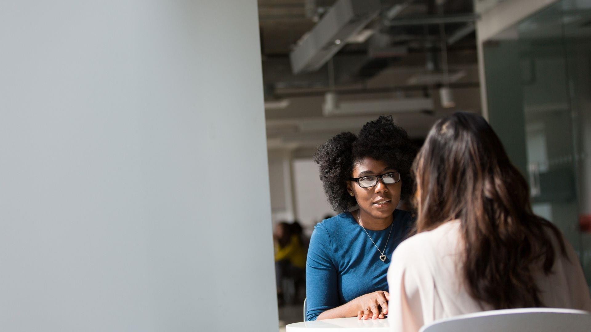 Two professional business women at meeting