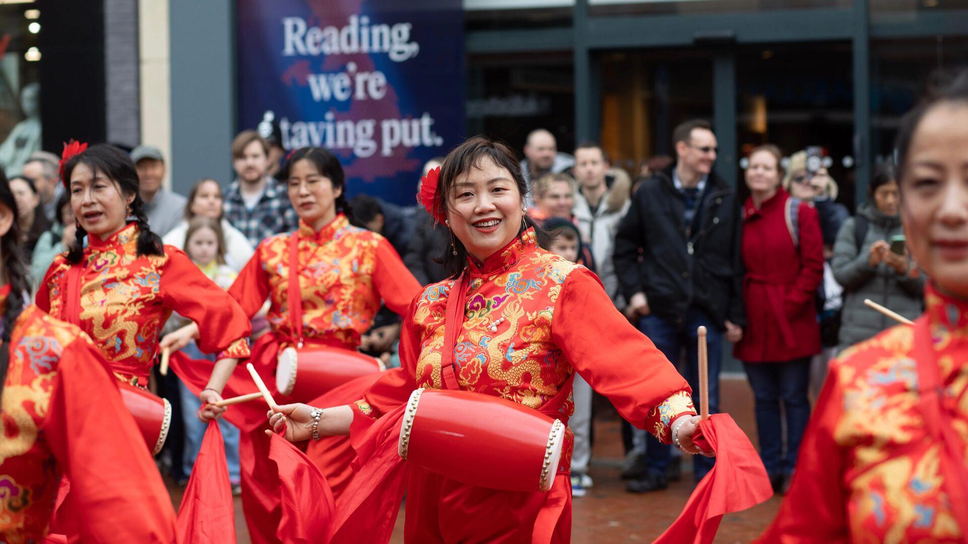 ladies dressed in Reading dancing on Broad Street for Chinese New Year