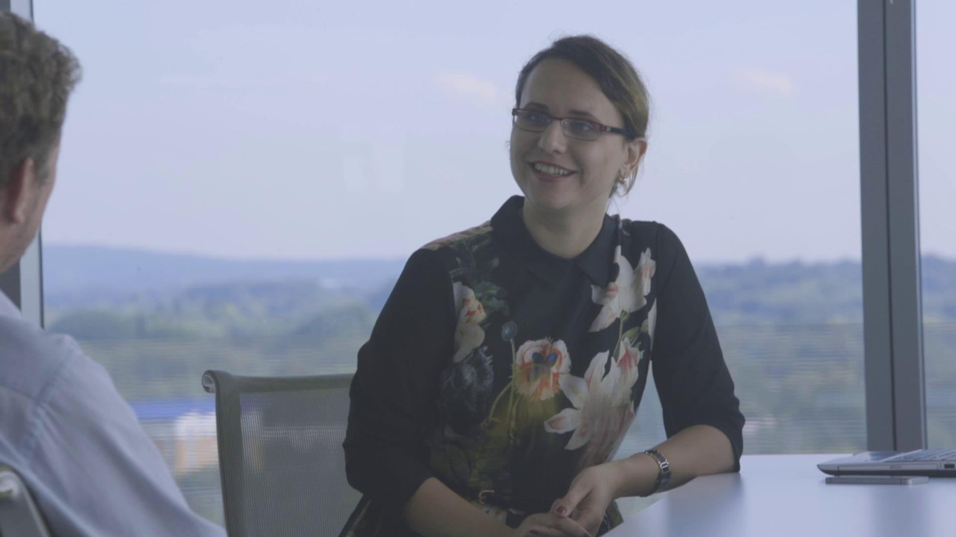 woman talking to man in business meeting room