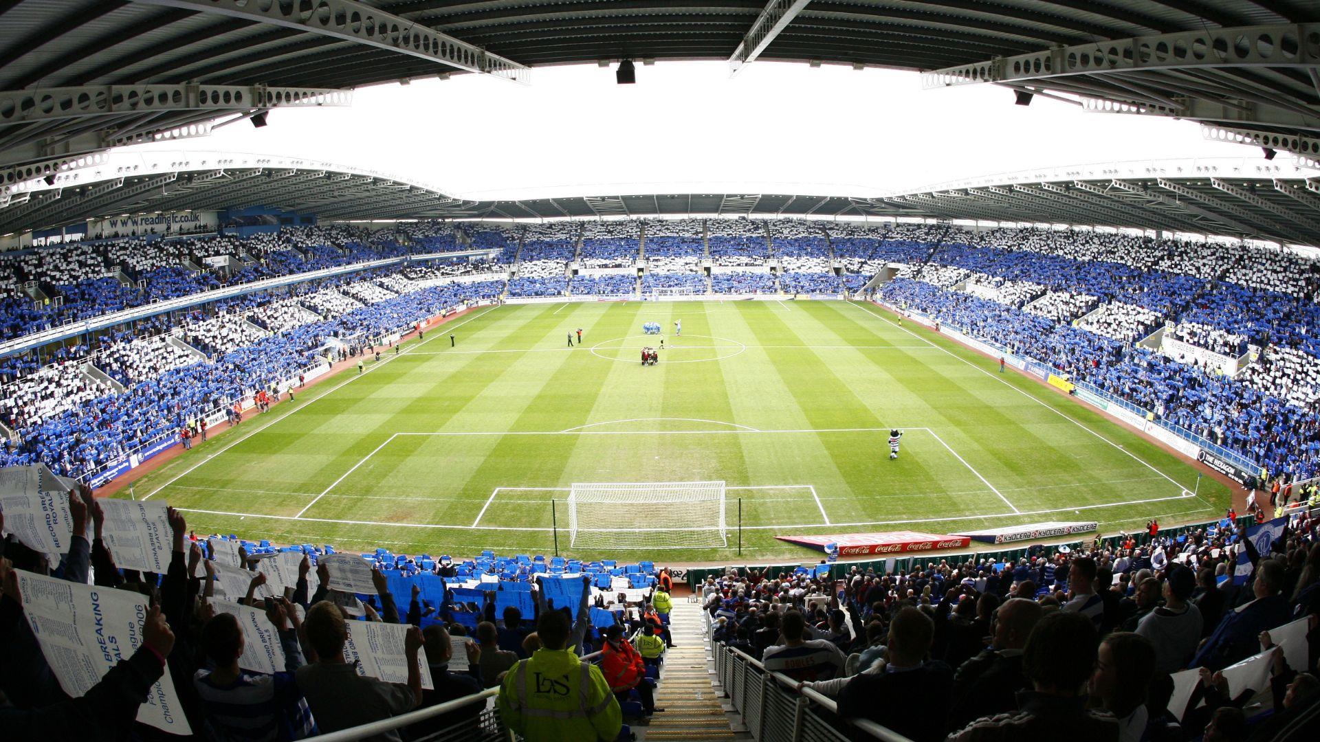 fans inside stadium hold up blue and white cards