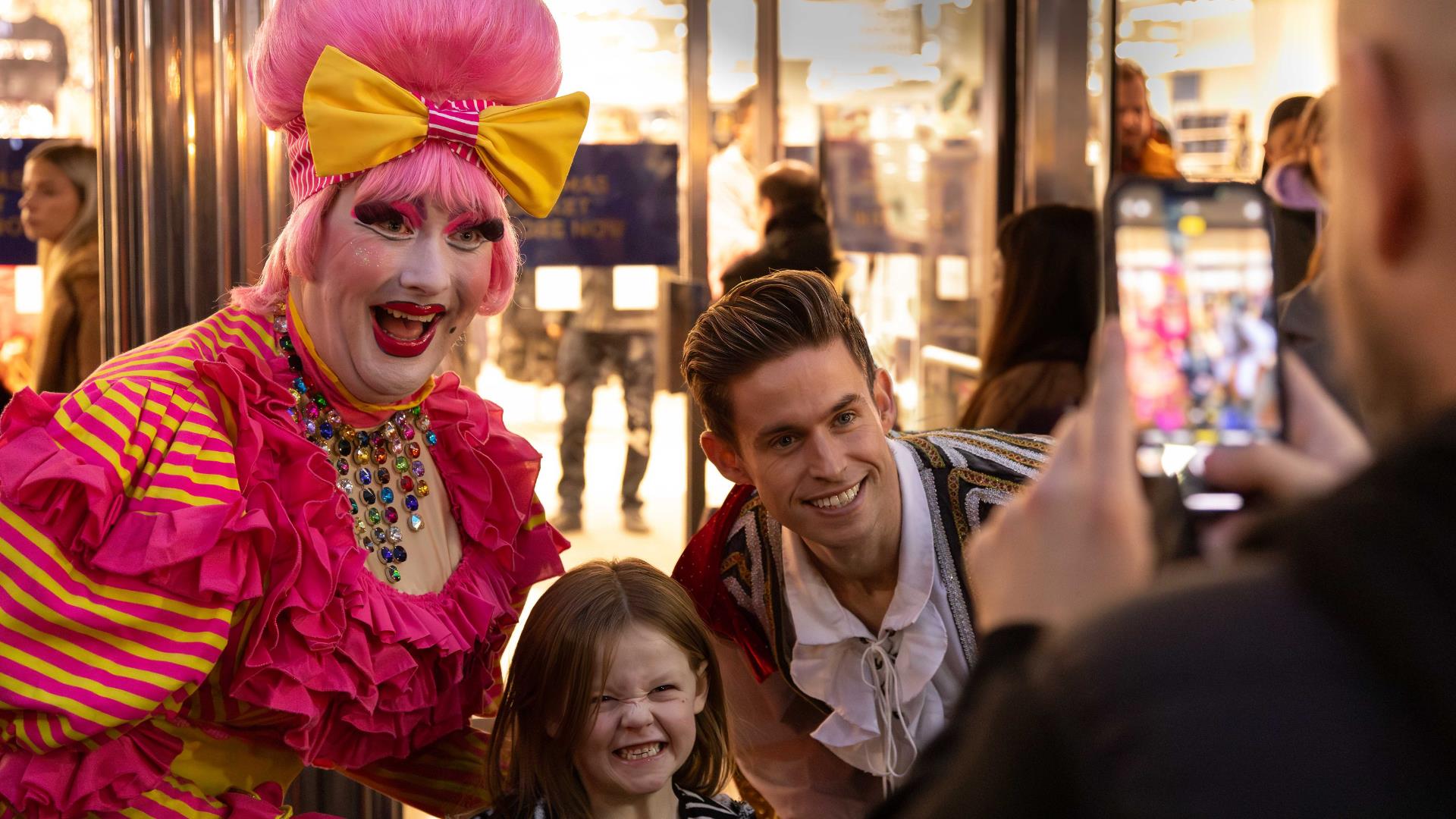 Pantomime dame in Reading taking a selfie with children