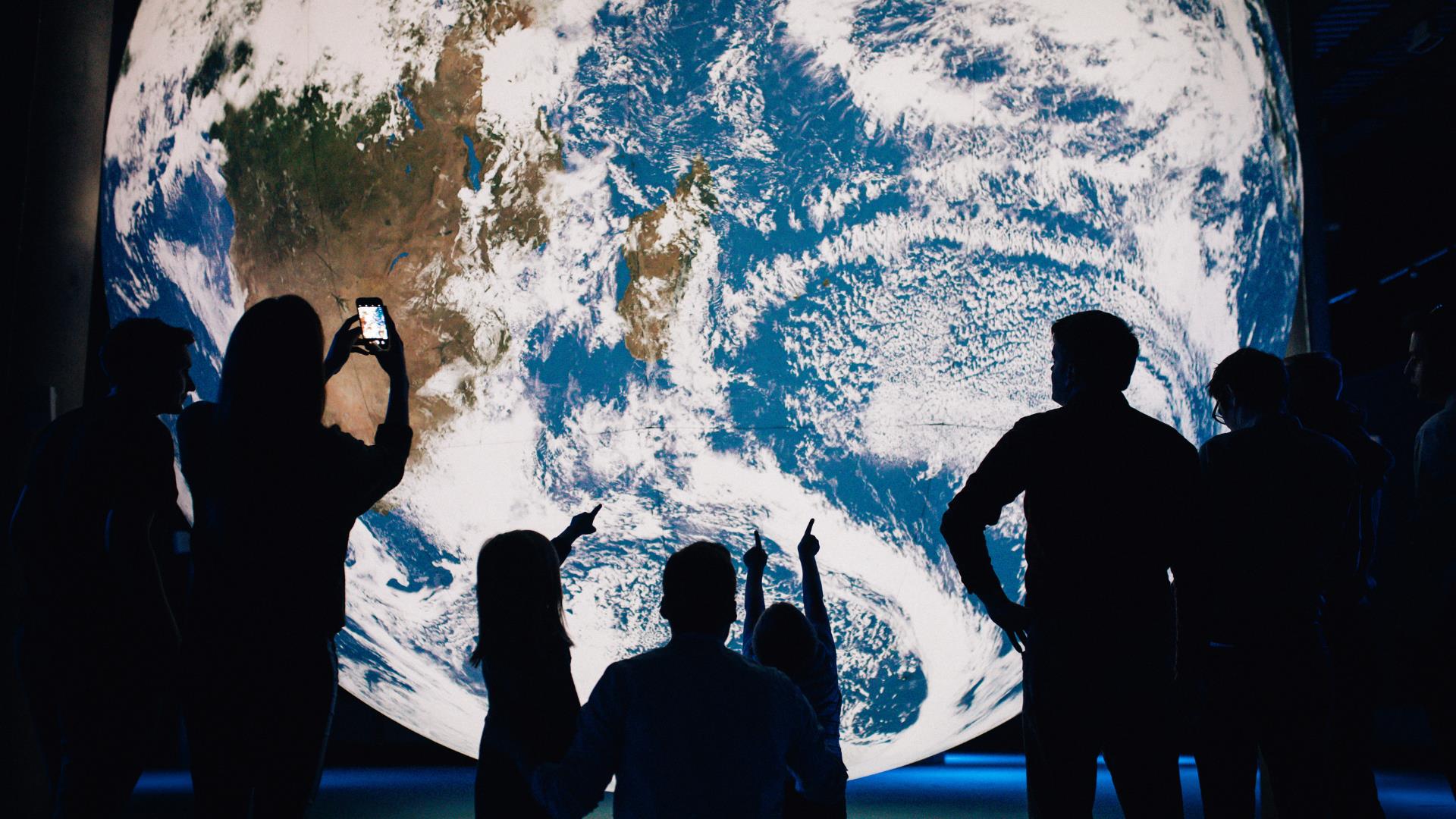 Crowds visiting Gaia globe installation