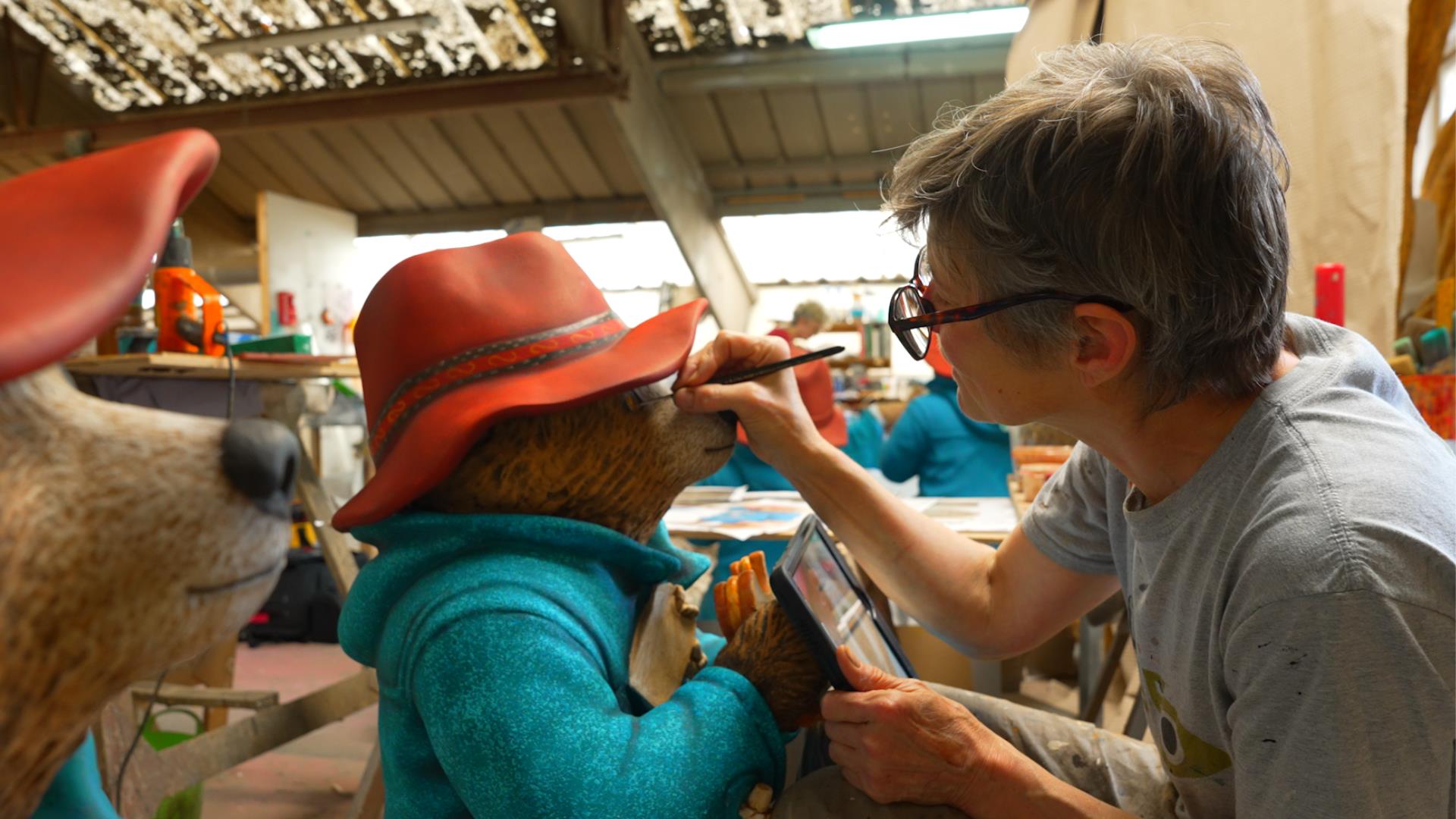 Artist painting statue of Paddington Bear