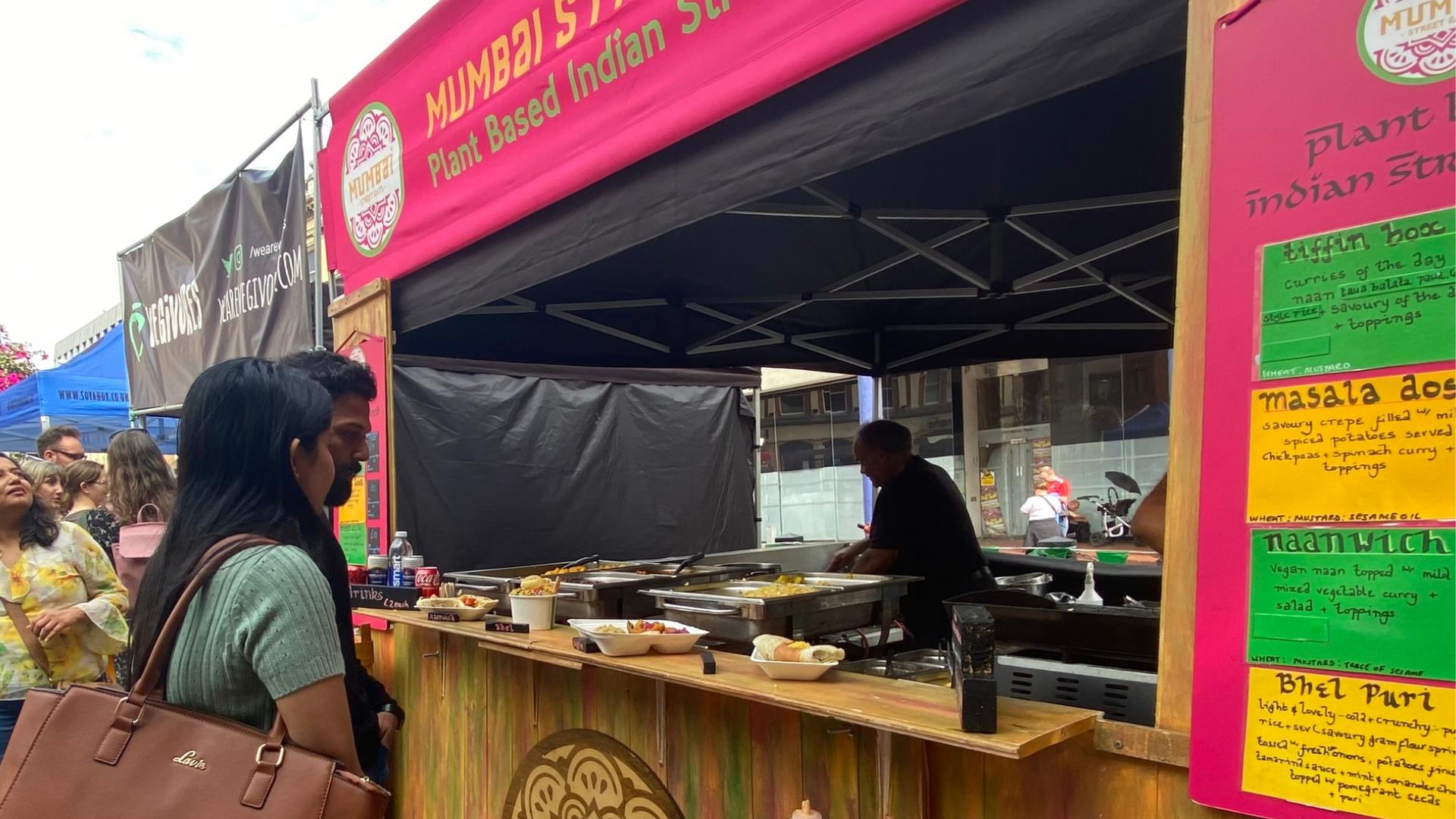 Man and woman waiting for food at Indian Street Food van during Reading Vegan Festival