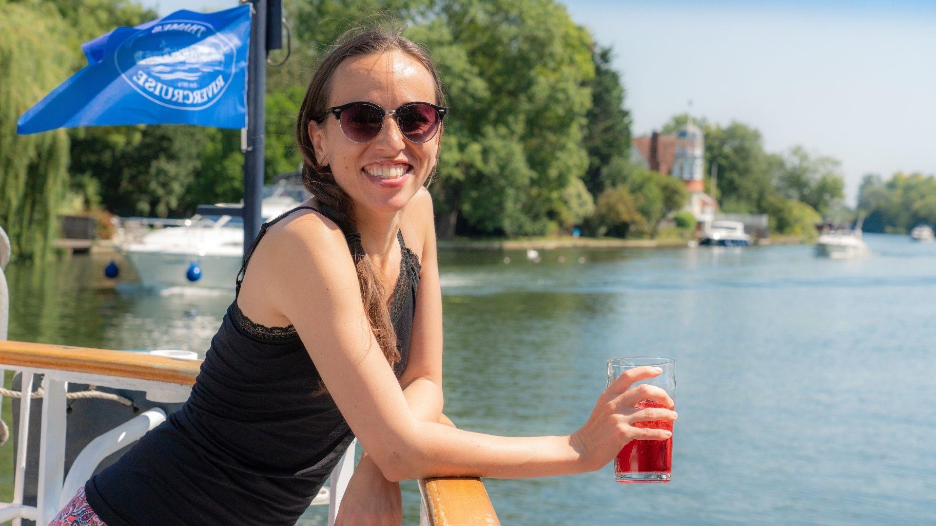 Lady drinking on board Thames River Cruise