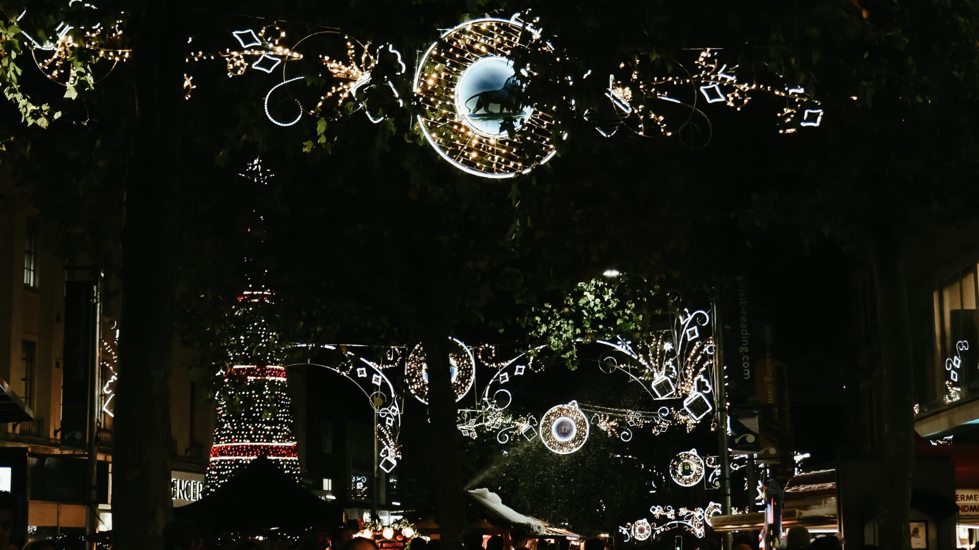 Christmas decorations and light at night time with Christmas tree in background