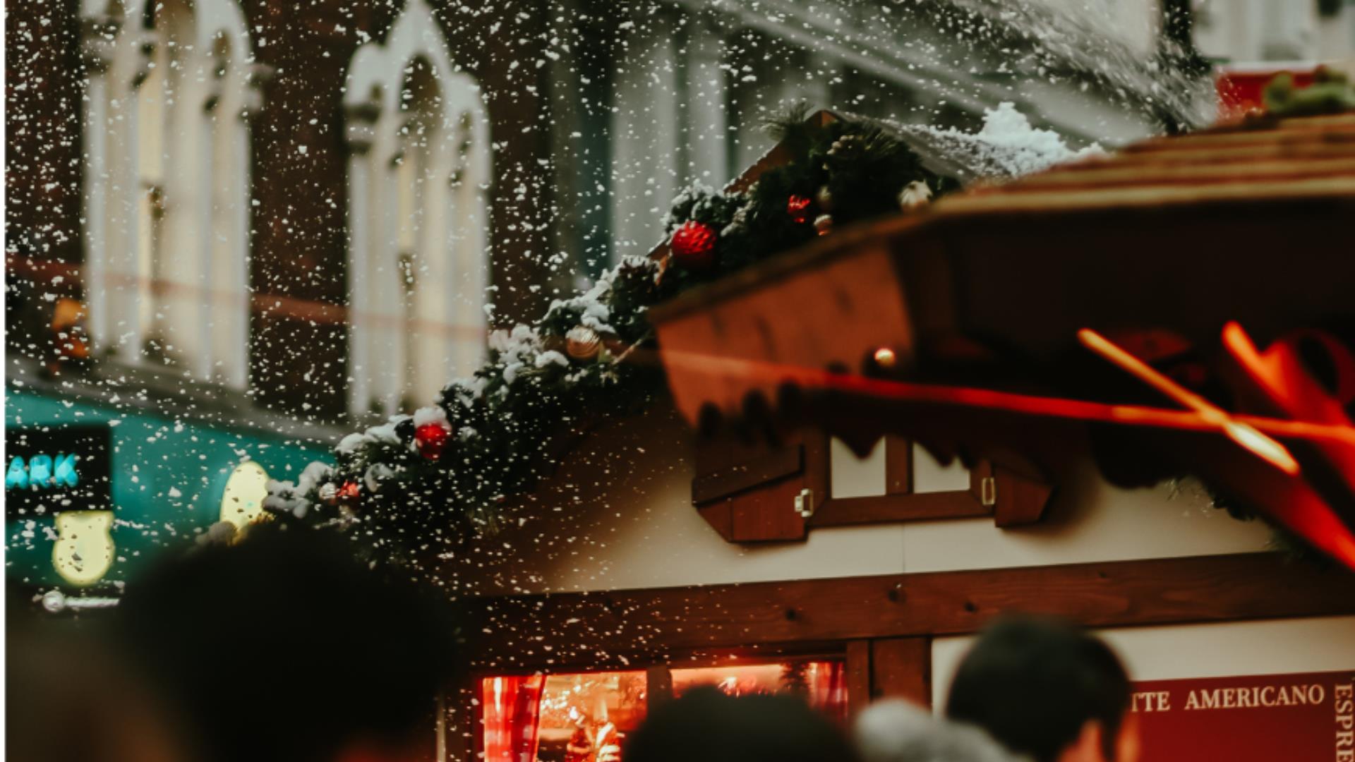 Snow falling around Christmas market roof