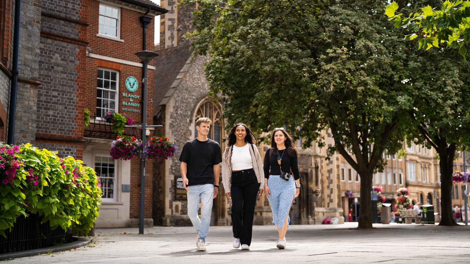 Friends walking beside St Lawrence Church