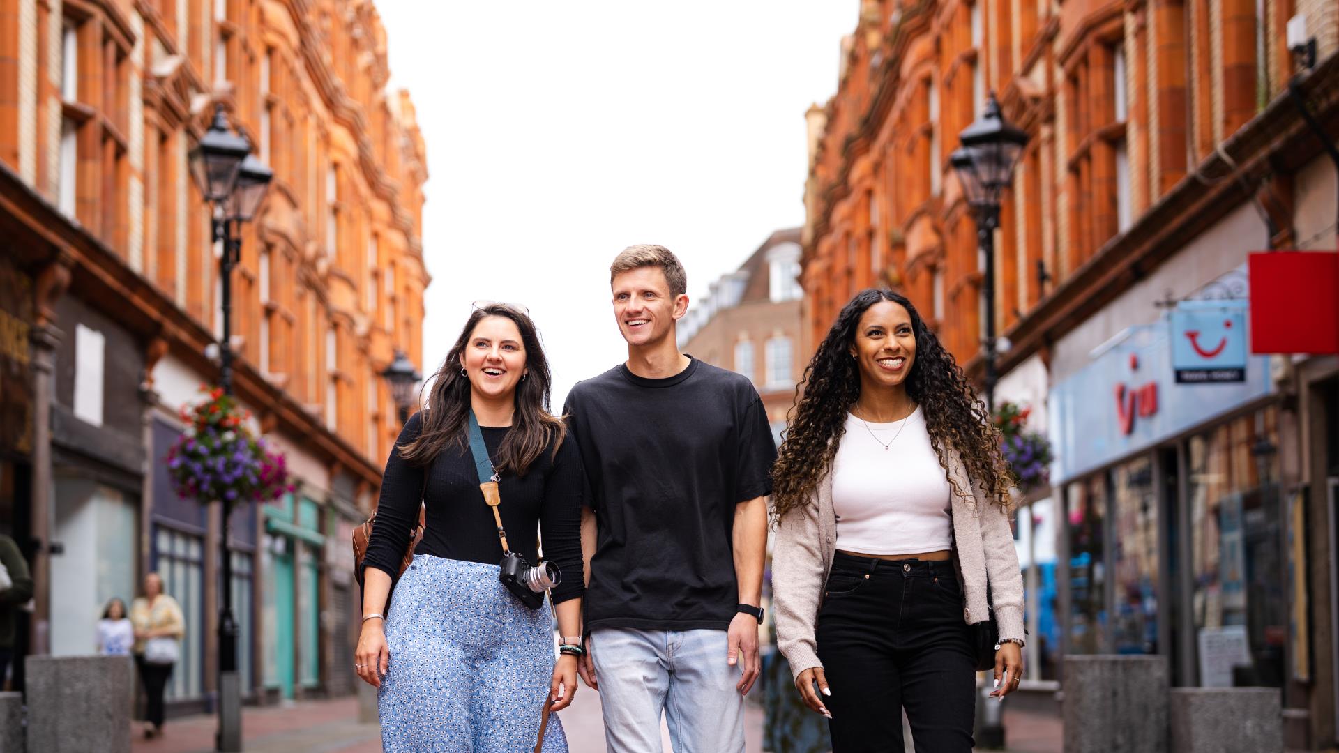 Friends walking through Reading town centre