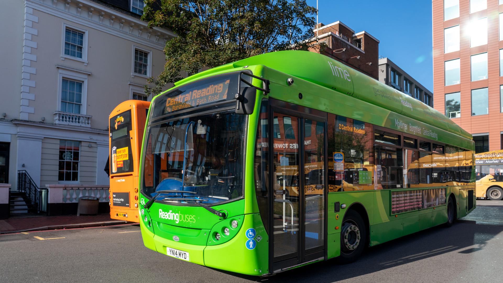 2 colourful single decker buses