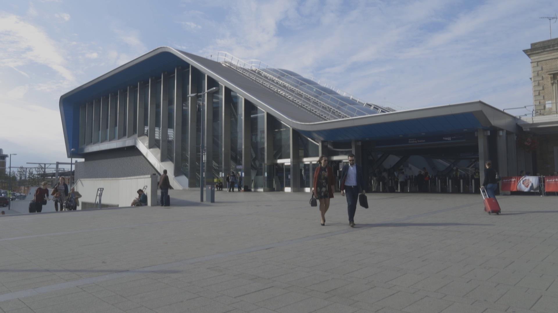 two people walking out of Reading station