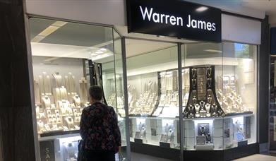 man looking in shop window