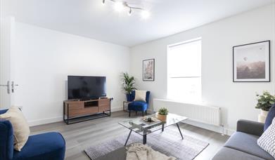 White room with TV and sofas