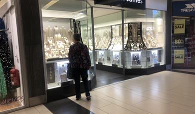 man looking in shop window