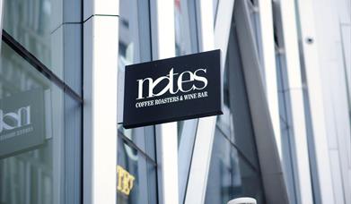 Sign reading 'Notes: coffee roasters & wine bar'