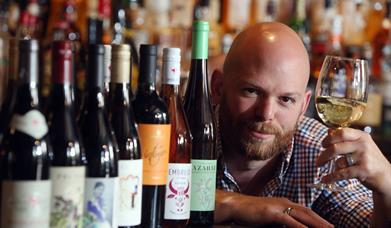 man holding glass of wine