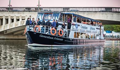 group at the front of a boat going under Caversham Bridge