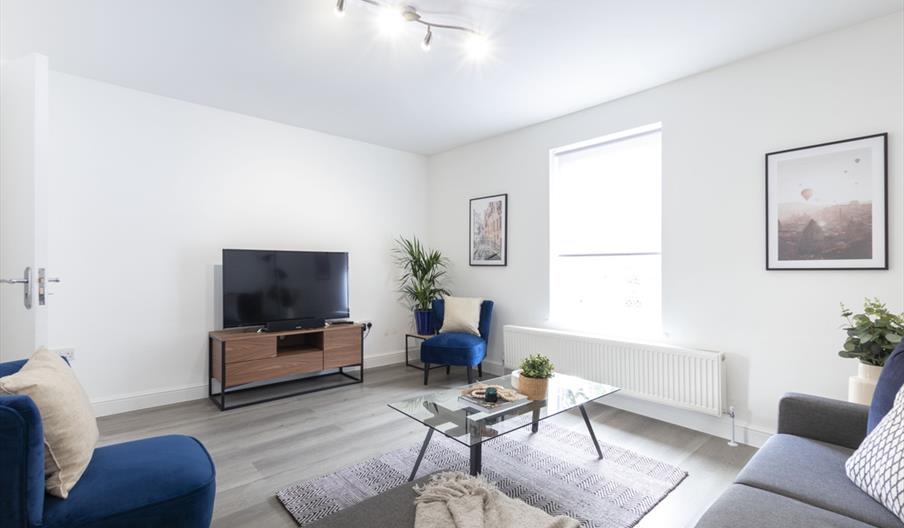 White room with TV and sofas