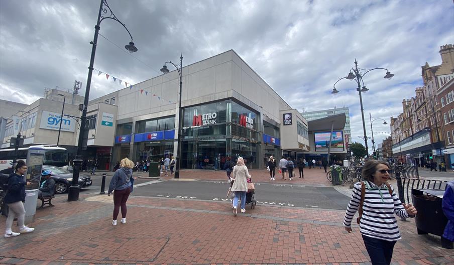 people walking in front of Metro Bank