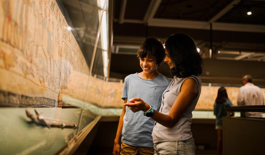A mum and son look at Britain's Bayeux Tapestry in Reading Museum