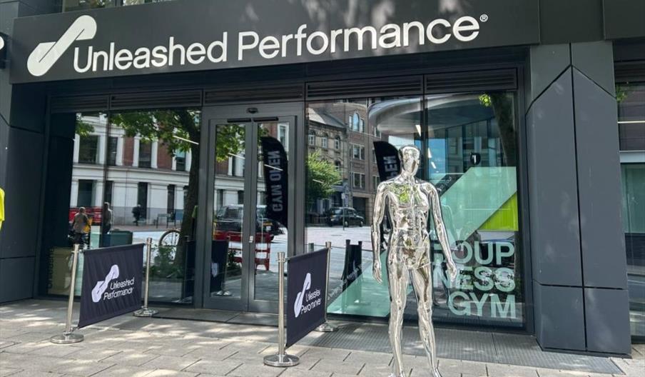 Front of building with metal mannequin outside