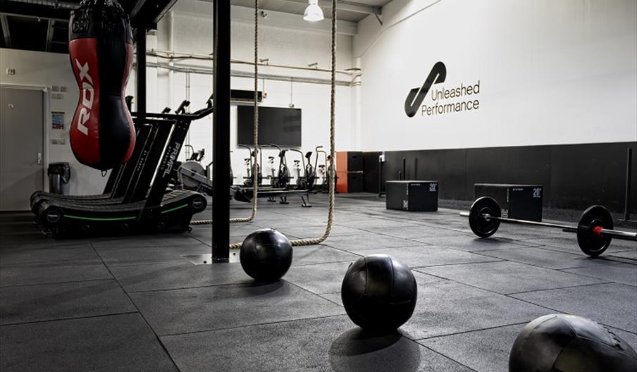 Gym equipment - weights, ropes and a punching bag