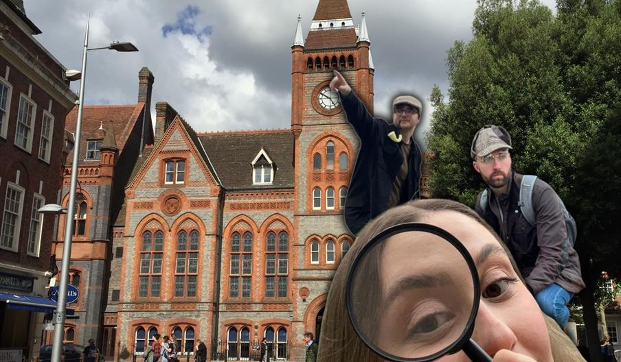 Girl with a magnifying glass in front of Reading Town Hall