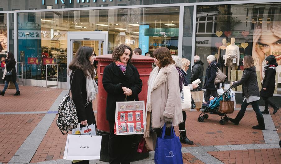 3 shoppers stood in front of Primark