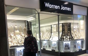man looking in shop window