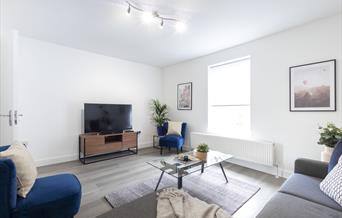 White room with TV and sofas