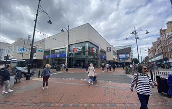 people walking in front of Metro Bank