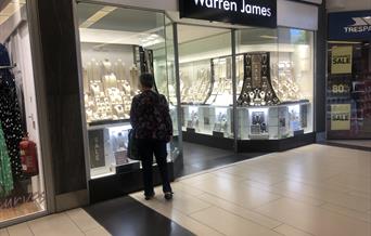 man looking in shop window