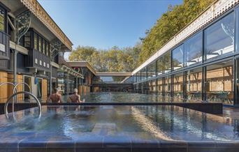 View of length of pool and hot tub