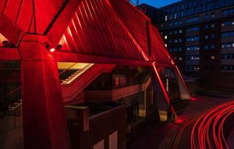 Night time outside the Hexagon with car lights