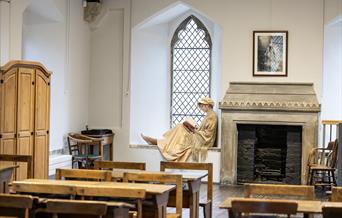 'Jane Austen' sitting in the window of her former schoolroom