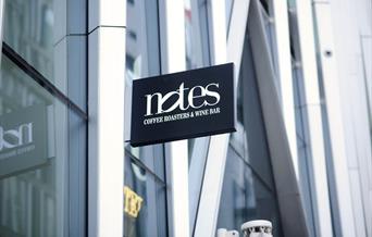 Sign reading 'Notes: coffee roasters & wine bar'