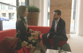 two people sat in reception area