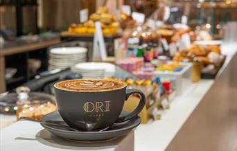 Mug with 'Ori Caffe' written on it in gold