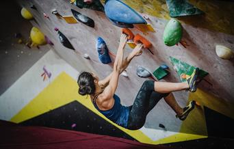 woman climbing indoors climbing wall