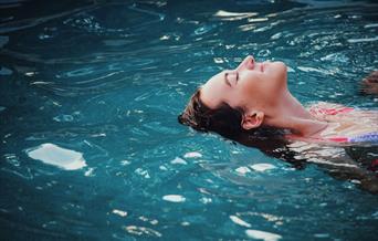 woman floating in pool