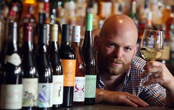 man holding glass of wine