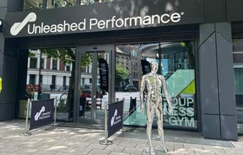 Front of building with metal mannequin outside