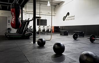 Gym equipment - weights, ropes and a punching bag