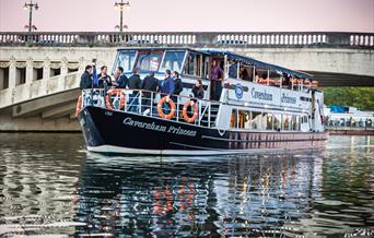 group at the front of a boat going under Caversham Bridge