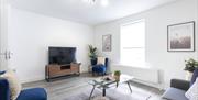 White room with TV and sofas