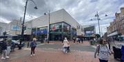 people walking in front of Metro Bank