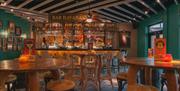 Tall tables in front of a bar