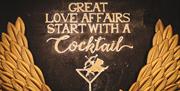 'Great love affairs start with a cocktail' mural